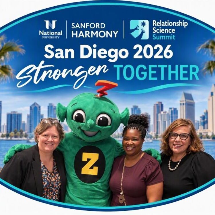 Four attendees pose with the Sanford Harmony mascot in a San Diego 2026 Stronger Together photo frame