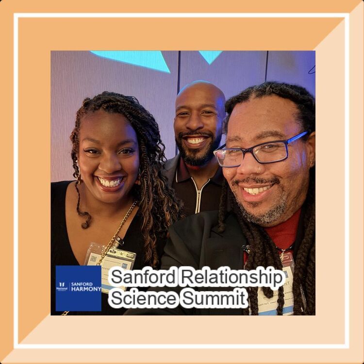 Three attendees smile together in a summit selfie